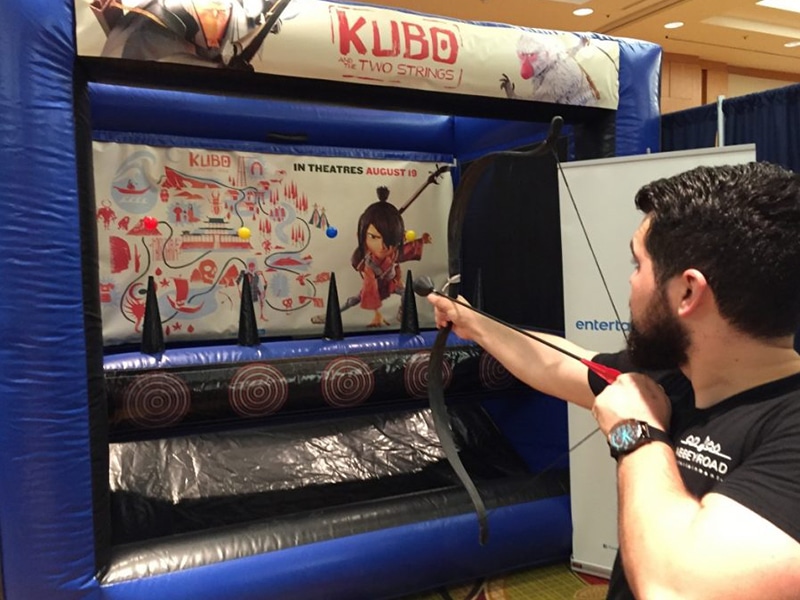 Man using the Inflatable Archery rental.