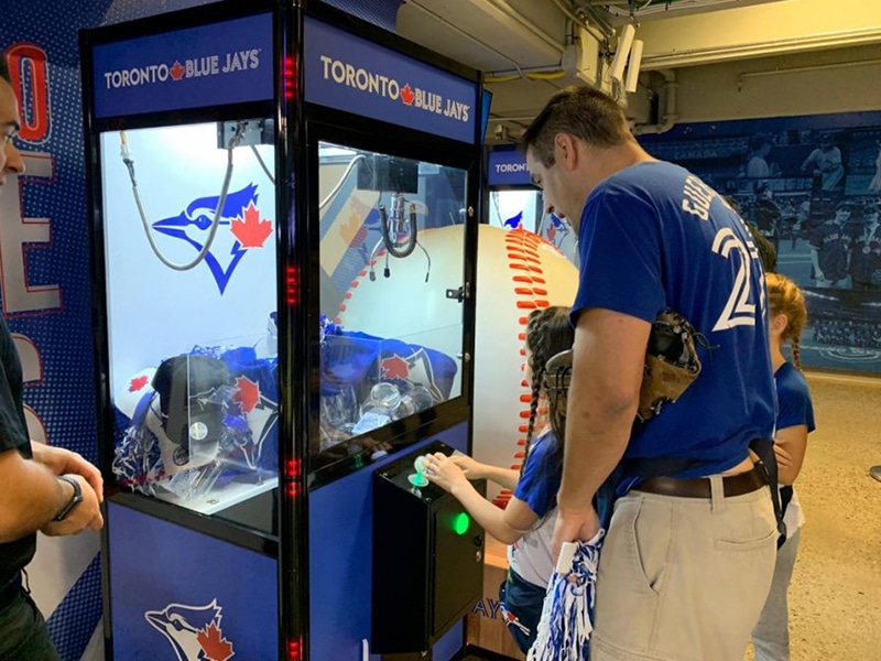 Child plays a round of the Arcade Crane Game in Toronto.