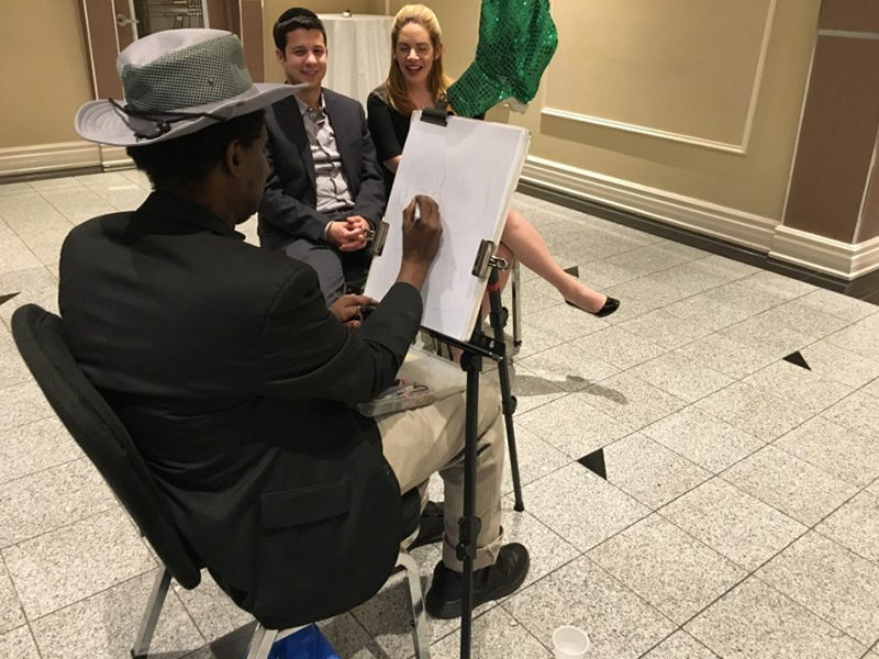 Caricature Artist drawing people for an event.