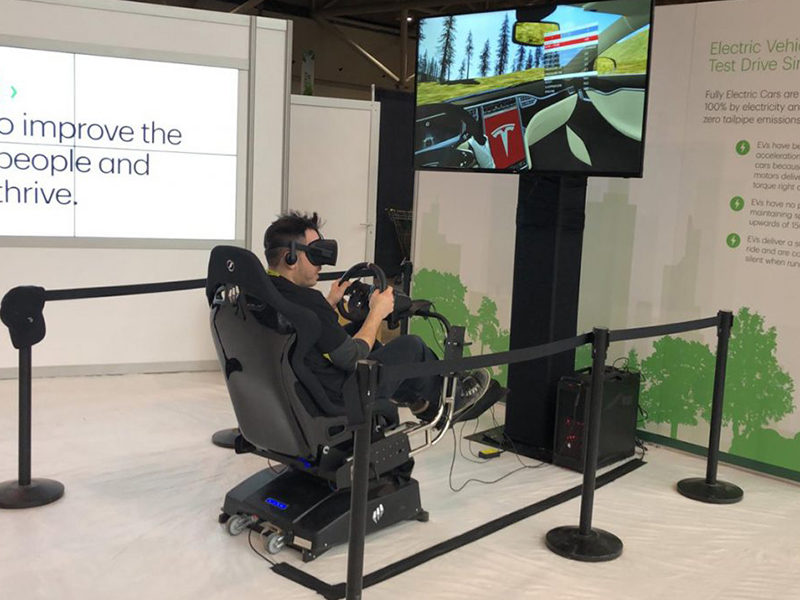 Man racing with the Full Motion VR Race Car Simulator rental.