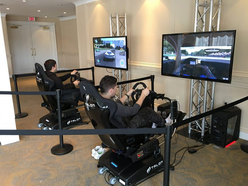 Two people racing with the Race Car Simulator.