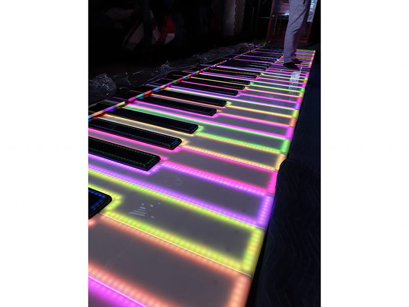 Giant Floor Piano Lit Up at an event.
