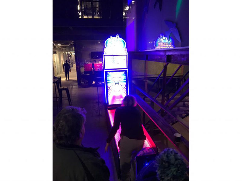 Woman playing the Lane Master Arcade Bowling rental.