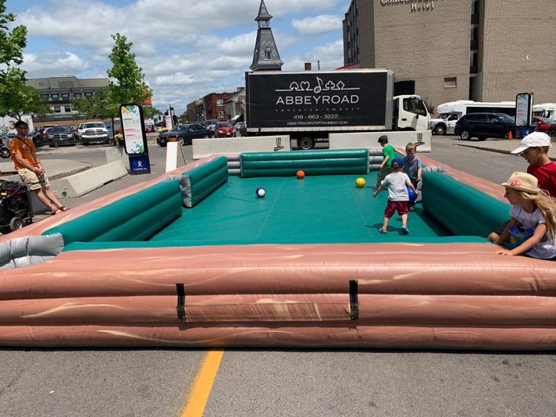 Kids having fun and playing the Inflatable Giant Billiards rental.