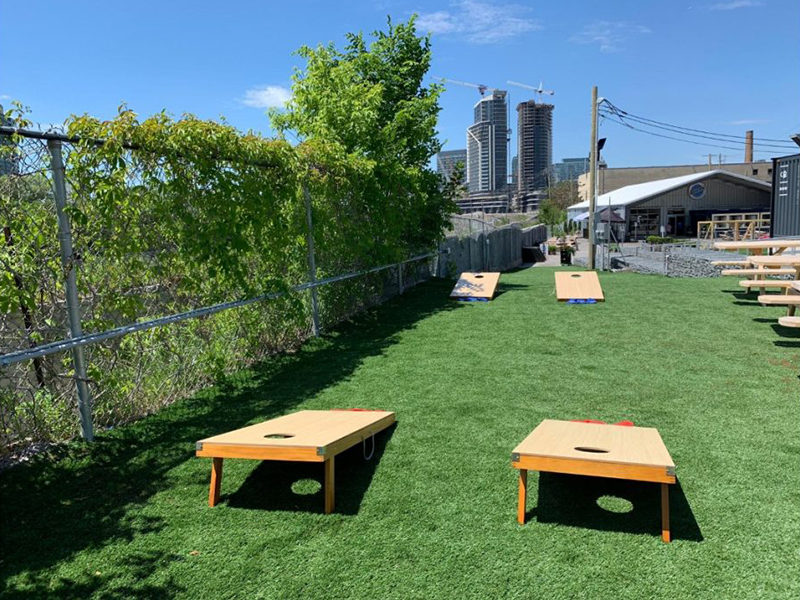 Two cornhole rentals set up for outdoor event in Toronto.