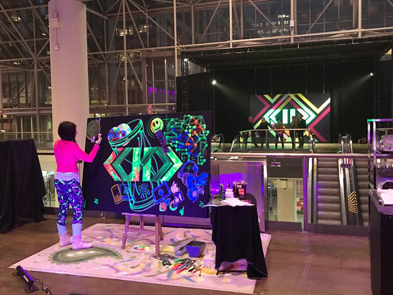 Woman Painting for a live art performance with Glow Paint.