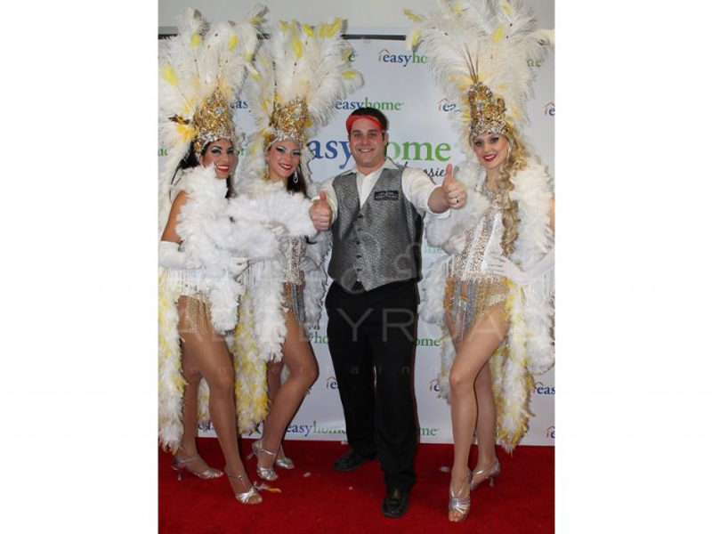 Three Show girls with worker at event in Toronto.