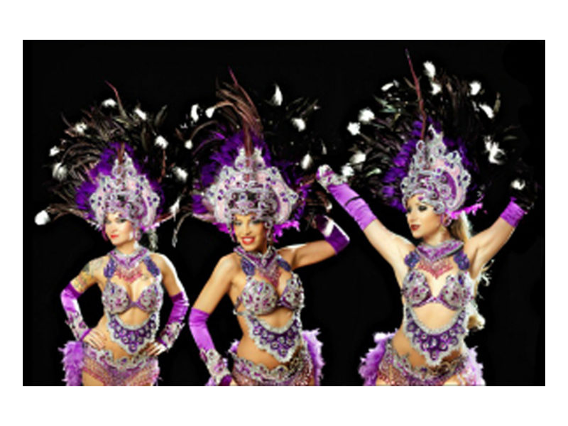 Three Showgirls ready to perform at event.