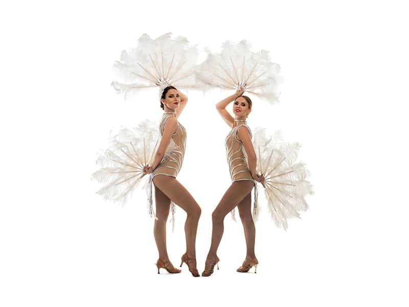 Two Showgirls posing in feather outfits in Toronto.