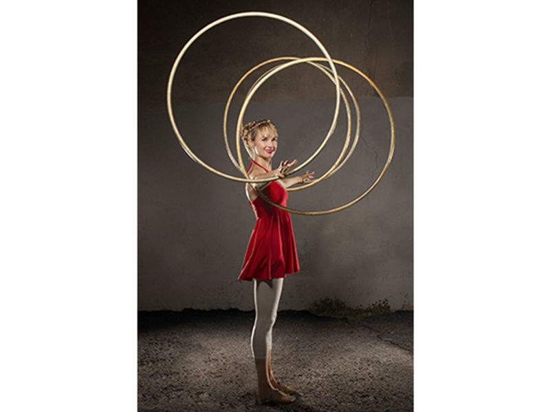 Woman performing with LED Hula Hoops.