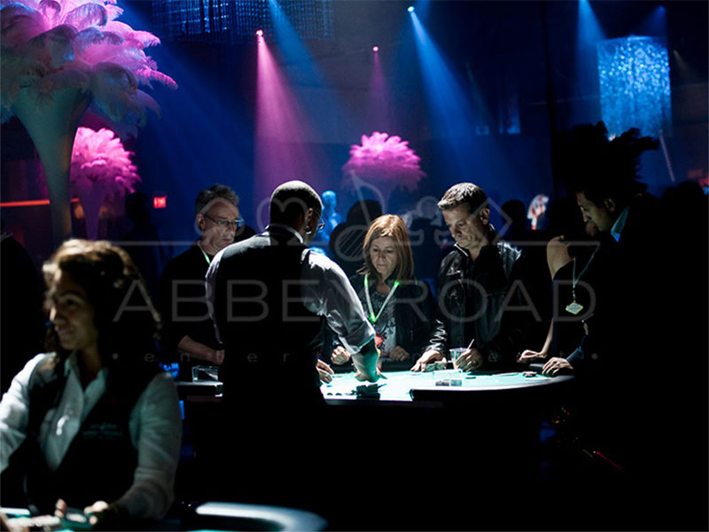 People placing bets at a Casino Table with Casino Dealers in Toronto.