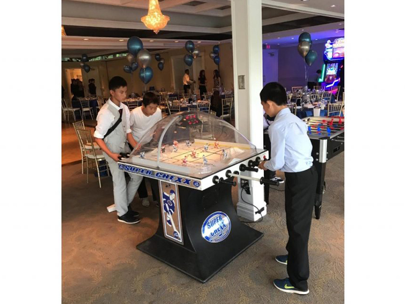People playing the Super Chexx Hockey rental at event in Toronto.