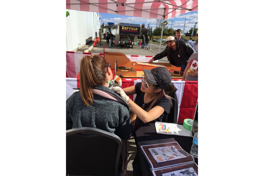 Glitter tattoo station at a staff event