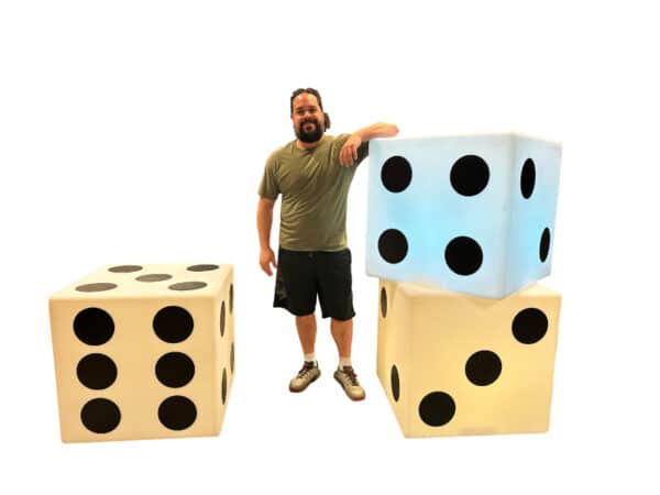 Giant LED dice available for event rentals in Toronto, glowing in vibrant colors at a party venue