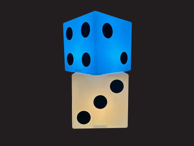 Guests playing with glowing giant LED dice at a Toronto event rental setup.