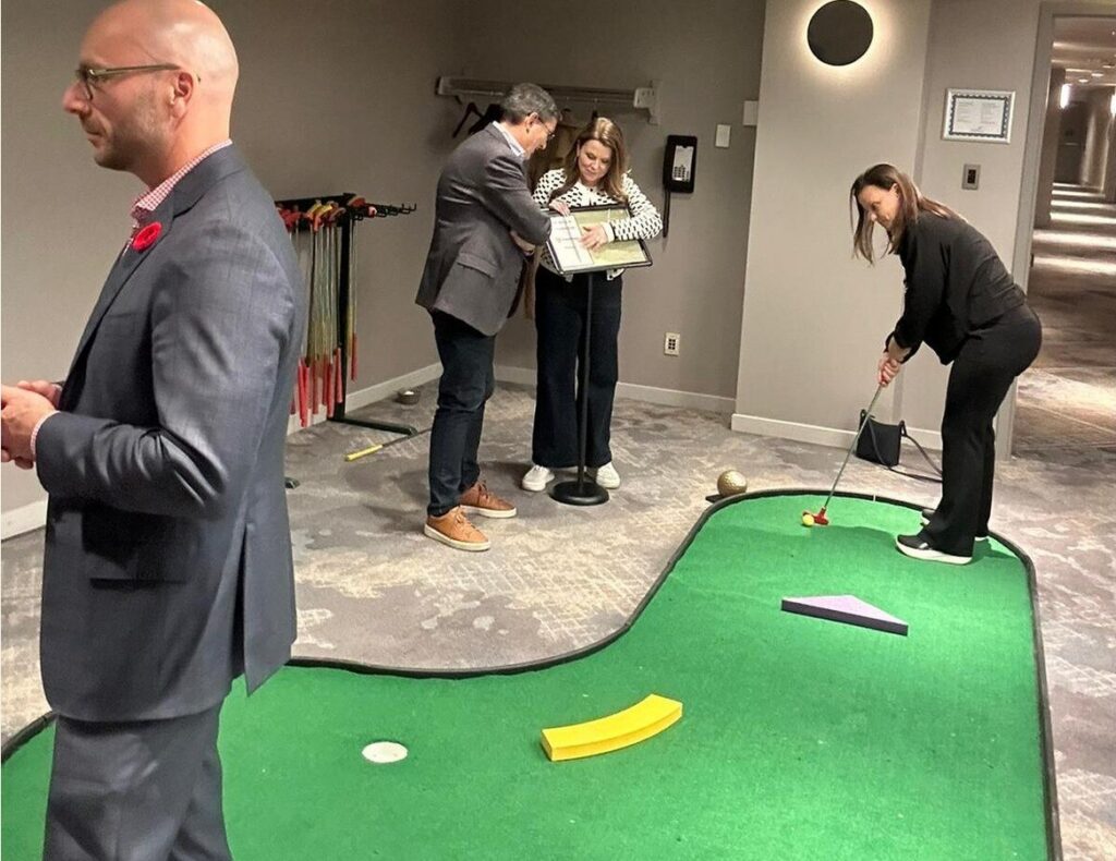 Employees collaborating during an interactive group challenge