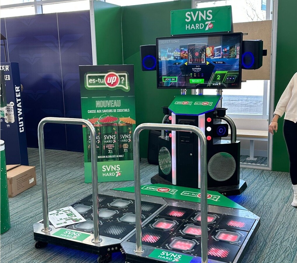 Exhibition booth featuring games, branding and attendee activities