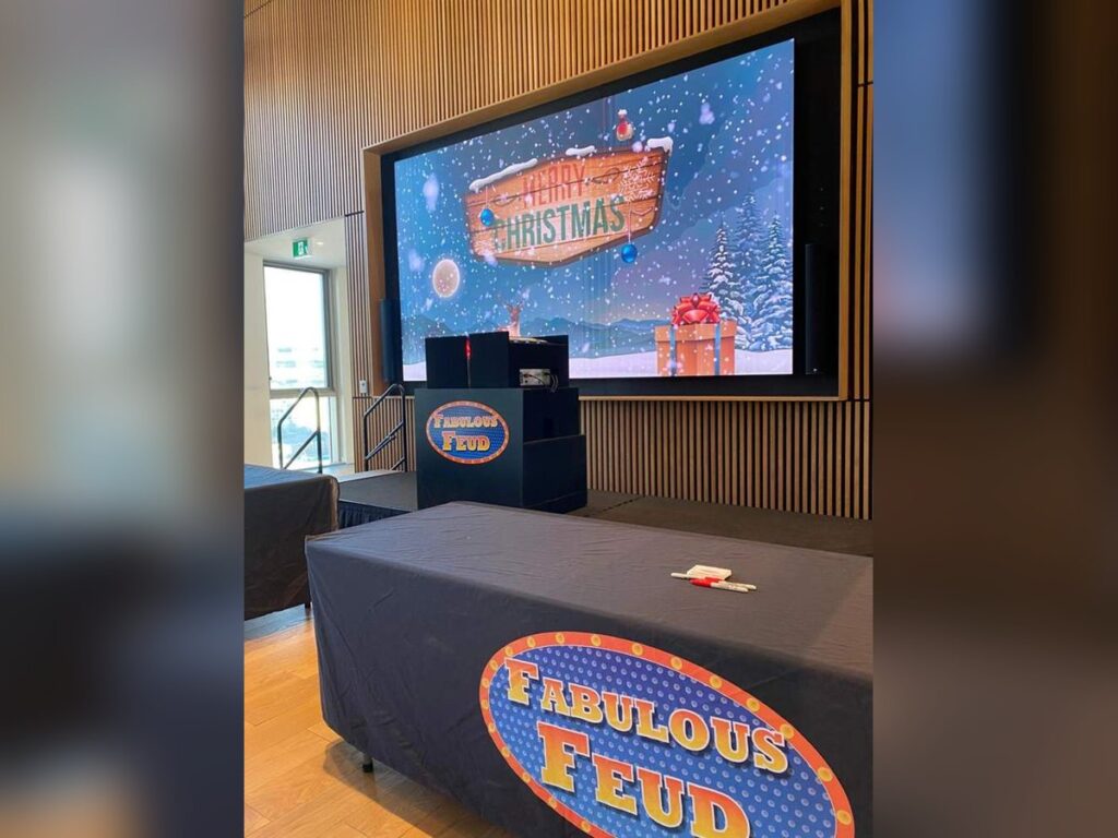 Employees competing in a hosted corporate game show